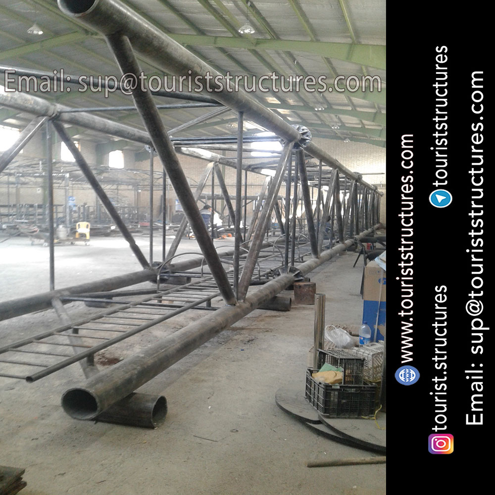 construction, color and carrying the structure, Location of metal frame factory (derrick and structures) of the aerial restaurant project in Ferdows Garden of Isfahan, Pasargad’s professional forces in welding, cutting and assembly at the factory, Steps to build the derrick for the aerial restaurant inside the factory in project of Ferdows Garden, Isfahan, Painting of project structures (with polyurethane paint, 120 microns thick) inside the factory in Ferdows Garden, Isfahan, Carrying of the project structures from the factory to the project site (in Ferdows Garden, Isfahan)