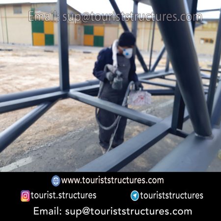 construction, color and carrying the structure, Location of metal frame factory (derrick and structures) of the aerial restaurant project in Ferdows Garden of Isfahan, Pasargad’s professional forces in welding, cutting and assembly at the factory, Steps to build the derrick for the aerial restaurant inside the factory in project of Ferdows Garden, Isfahan, Painting of project structures (with polyurethane paint, 120 microns thick) inside the factory in Ferdows Garden, Isfahan, Carrying of the project structures from the factory to the project site (in Ferdows Garden, Isfahan)